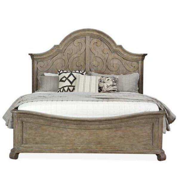 Antique carved wood bed with a rustic finish.