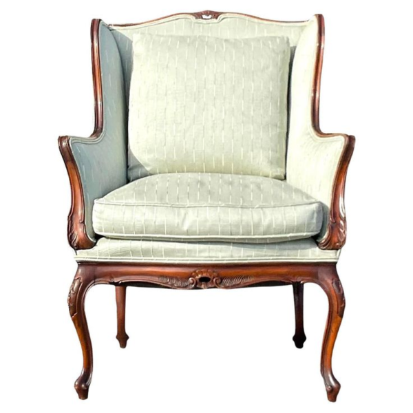 Classic beige wingback sofa with carved wood frame