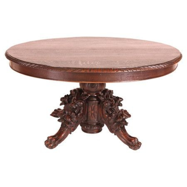 Victorian-style wood dining table with carved pedestal base