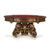Antique Baroque style dining table with red faux leather top and ornate carvings