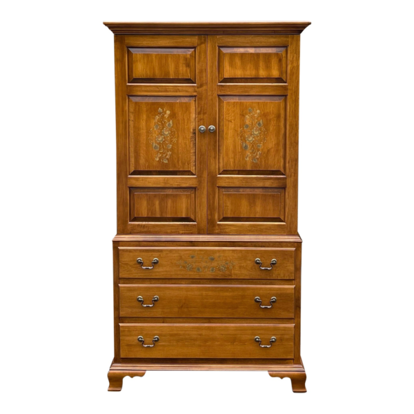 Brown wood armoire with floral inlay and storage drawers