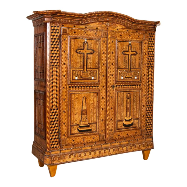 Antique wooden armoire with intricate inlay design
