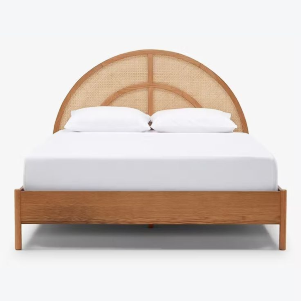 Mid-Century Modern bed with rattan headboard and natural wood frame