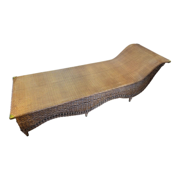 Luxury rattan chaise lounge, woven outdoor lounger, handcrafted patio furniture, designer rattan sunbed.