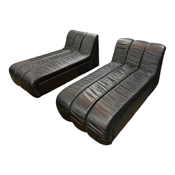 Black leather chaise lounge, modular sofa design, 1970s furniture, luxury leather seating, modern living room sofa.