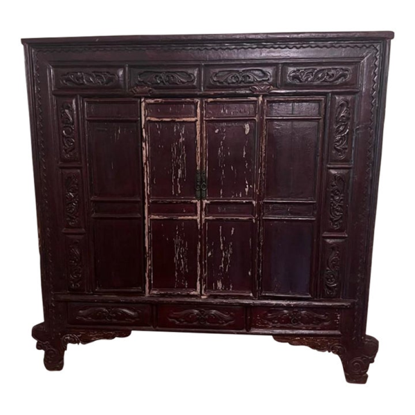 Classic dark brown wood armoire with ornate detailing.