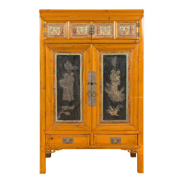 Yellow and black wood armoire with carved panels