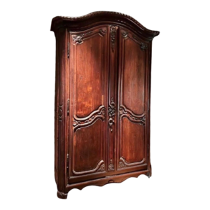 Detailed carvings and dark brown finish of a vintage French style wood wardrobe