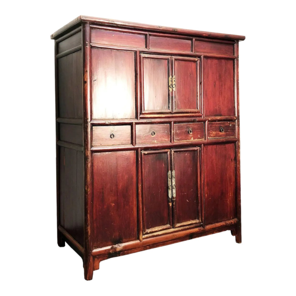 Vintage wood armoire with multiple doors and drawers.