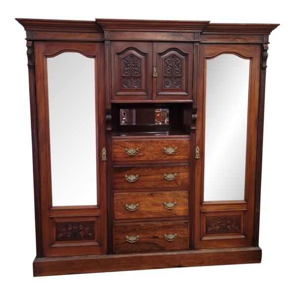Vintage wooden armoire with mirror doors and carved details